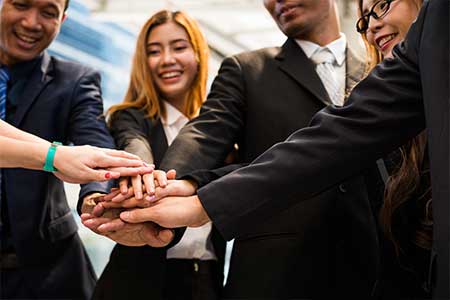 Young girl wearing suits handshake with her asian employee out of the office after meeting with big group company in Asia